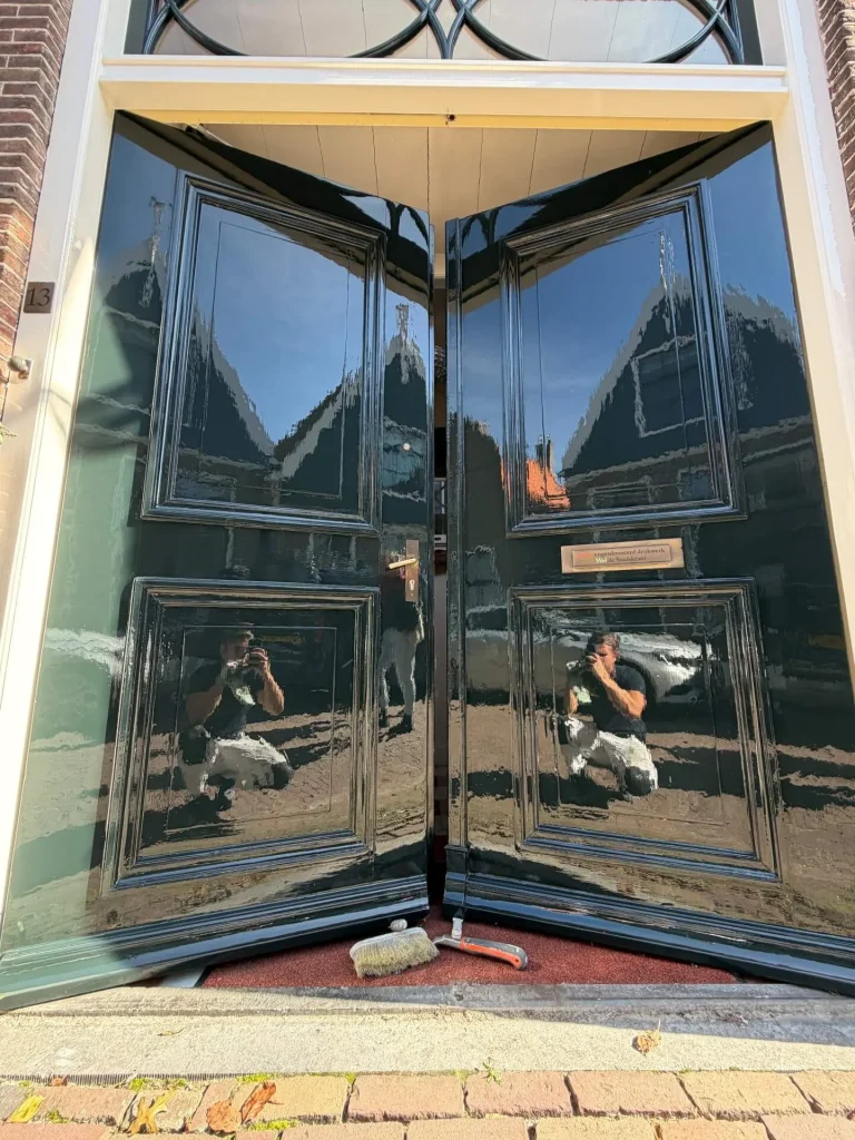 Glimmend zwart geschilderde dubbele voordeur van huisnummer 13 aan de Lingerzijde in Edam